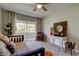 Bright bedroom featuring seating area, a ceiling fan, and sliding glass doors to balcony at 2323 Feather Sound Dr # F101, Clearwater, FL 33762