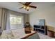 Bright bedroom featuring a ceiling fan, a balcony, and a neutral color scheme at 2323 Feather Sound Dr # F101, Clearwater, FL 33762