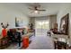 Bright bedroom with seating area, a ceiling fan, and sliding glass doors to a balcony at 2323 Feather Sound Dr # F101, Clearwater, FL 33762