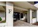 Building entrance with letter F above the doorway, tile flooring, and plants at 2323 Feather Sound Dr # F101, Clearwater, FL 33762