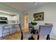 This open floor plan features a dining room with a glass table and seating for four at 2323 Feather Sound Dr # F101, Clearwater, FL 33762