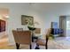 Open floor plan features a dining room with a glass table and seating for four at 2323 Feather Sound Dr # F101, Clearwater, FL 33762
