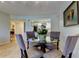 Open floor plan features a dining room with a glass table and seating for four guests at 2323 Feather Sound Dr # F101, Clearwater, FL 33762