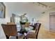 Open floor plan features a dining room with a glass table and seating for four guests at 2323 Feather Sound Dr # F101, Clearwater, FL 33762