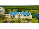 Beautiful exterior of the property with its blue roof, well-maintained grounds, and peaceful pond views at 2323 Feather Sound Dr # F101, Clearwater, FL 33762