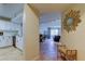 Hallway view into living room, dining room and kitchen with a decorative sunburst mirror at 2323 Feather Sound Dr # F101, Clearwater, FL 33762