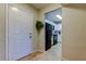 Hallway view to the kitchen featuring white cabinets and black appliances at 2323 Feather Sound Dr # F101, Clearwater, FL 33762