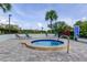 Relaxing hot tub with lounge chairs, tropical landscaping, and a welcoming atmosphere on a sunny day at 2323 Feather Sound Dr # F101, Clearwater, FL 33762