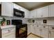 Updated kitchen featuring white cabinets, black appliances and white subway tile backsplash at 2323 Feather Sound Dr # F101, Clearwater, FL 33762