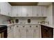 Updated kitchen featuring white cabinets, modern hardware, and subway tile backsplash at 2323 Feather Sound Dr # F101, Clearwater, FL 33762