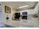 Bright kitchen featuring white cabinets and quartz countertops with black appliances at 2323 Feather Sound Dr # F101, Clearwater, FL 33762