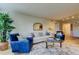 Bright living room features stylish furniture, a decorative mirror, and a lush indoor plant at 2323 Feather Sound Dr # F101, Clearwater, FL 33762