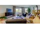 Bright living room with modern furniture, cozy seating, and a sliding door to the outside at 2323 Feather Sound Dr # F101, Clearwater, FL 33762