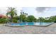 Beautiful swimming pool with lounge chairs and mature tropical landscaping at 2323 Feather Sound Dr # F101, Clearwater, FL 33762