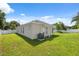 View of the home's rear, showcasing a well-maintained lawn and exterior details at 2816 Pankaw Ln, Valrico, FL 33596
