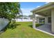 Expansive backyard featuring a covered patio and a white fence for privacy at 2816 Pankaw Ln, Valrico, FL 33596