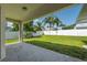 Covered patio overlooking a well-maintained, grassy backyard and fenced perimeter at 2816 Pankaw Ln, Valrico, FL 33596