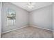 Neutral bedroom with carpet flooring, ceiling fan, and a window for natural light at 2816 Pankaw Ln, Valrico, FL 33596