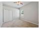 Cozy bedroom with carpeted flooring, a ceiling fan, and a window at 2816 Pankaw Ln, Valrico, FL 33596