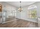 Elegant dining room showcasing wood flooring, natural light, and a large decorative mirror at 2816 Pankaw Ln, Valrico, FL 33596