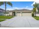 Inviting single-story home boasting an expansive driveway, lush landscaping, and a convenient three-car garage at 2816 Pankaw Ln, Valrico, FL 33596