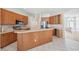 Spacious kitchen with stainless steel appliances, wood cabinets and island with barstool seating at 2816 Pankaw Ln, Valrico, FL 33596