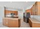 Well-lit kitchen features stainless steel appliances, wooden cabinets, and tiled floor at 2816 Pankaw Ln, Valrico, FL 33596