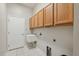 Practical laundry room with overhead cabinets, sink, and washer/dryer hookups at 2816 Pankaw Ln, Valrico, FL 33596