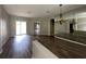 Open-concept living room featuring wood floors, and sliding glass doors to the outdoor space at 2816 Pankaw Ln, Valrico, FL 33596