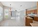 Open floor plan featuring tile flooring, hanging chandelier, and natural light from the window at 2816 Pankaw Ln, Valrico, FL 33596