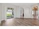 Open living room with a sliding glass door and wood-look floors at 2816 Pankaw Ln, Valrico, FL 33596