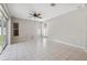 Bright living room with tile flooring, ceiling fan, and lots of natural light from sliding doors at 2816 Pankaw Ln, Valrico, FL 33596