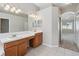 Bright main bathroom with double vanity, tile flooring, and lots of natural light at 2816 Pankaw Ln, Valrico, FL 33596