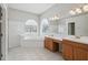 Bright main bathroom with double vanity, soaking tub, and separate shower at 2816 Pankaw Ln, Valrico, FL 33596