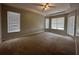 Main bedroom features carpet flooring, tray ceiling, ceiling fan and natural light from several windows at 2816 Pankaw Ln, Valrico, FL 33596