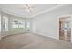 Bright main bedroom with tray ceiling, carpeted flooring, and a doorway to the ensuite bath at 2816 Pankaw Ln, Valrico, FL 33596