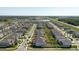An aerial view of a residential community shows the home's position with pond and road access at 3047 Adams Cross Dr, Zephyrhills, FL 33540