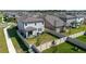 Aerial view of fenced backyard and neighboring houses showcases the property at 3047 Adams Cross Dr, Zephyrhills, FL 33540