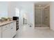 Spacious bathroom with large tiled shower, granite countertops, and bright neutral finishes at 3047 Adams Cross Dr, Zephyrhills, FL 33540