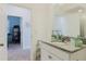 Bathroom with single sink vanity and doorway to a room with office area at 3047 Adams Cross Dr, Zephyrhills, FL 33540