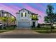 Beautiful two-story house with a lush front yard and colorful sunset backdrop at 3047 Adams Cross Dr, Zephyrhills, FL 33540