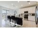 Bright kitchen with white cabinets, granite countertops, and stainless steel appliances at 3047 Adams Cross Dr, Zephyrhills, FL 33540