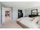 Spacious main bedroom, featuring neutral decor, a large window for natural light, and access to other rooms at 3047 Adams Cross Dr, Zephyrhills, FL 33540