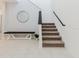 Modern staircase design with a neutral carpet, sleek black handrail, and decorative bench seating at 3047 Adams Cross Dr, Zephyrhills, FL 33540