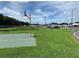 Outdoor basketball court featuring a grassy area, and chain link fence at 3111 Great Oak St, Wesley Chapel, FL 33543