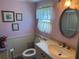 This bathroom shows a classic white toilet, single sink vanity, and oval mirror over the sink at 3111 Great Oak St, Wesley Chapel, FL 33543
