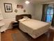 Comfortable bedroom with wood laminate floors, a queen bed and bright natural light at 3111 Great Oak St, Wesley Chapel, FL 33543