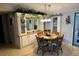 Cozy dining area with wooden table, chairs and a hutch with floral decor accents at 3111 Great Oak St, Wesley Chapel, FL 33543