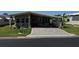 Exterior view of a single story home with covered parking and mature landscaping at 3111 Great Oak St, Wesley Chapel, FL 33543
