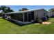The exterior of this single Gathering home features a screened porch and mature landscaping at 3111 Great Oak St, Wesley Chapel, FL 33543